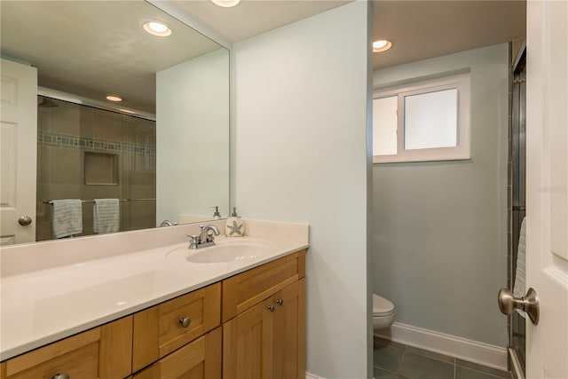 bathroom with a shower with door, tile patterned flooring, vanity, and toilet