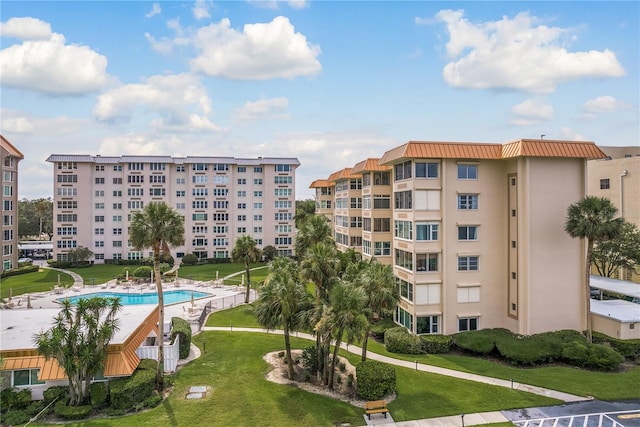 view of building exterior featuring a community pool