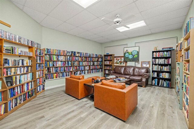 sitting room featuring light hardwood / wood-style flooring and a drop ceiling