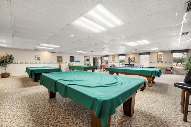 rec room featuring a paneled ceiling and carpet