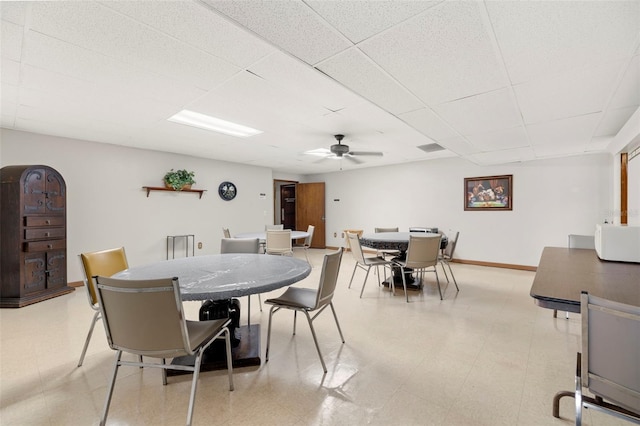 dining area featuring a paneled ceiling and ceiling fan