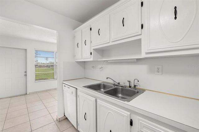 kitchen featuring dishwasher, light tile patterned floors, white cabinetry, and sink