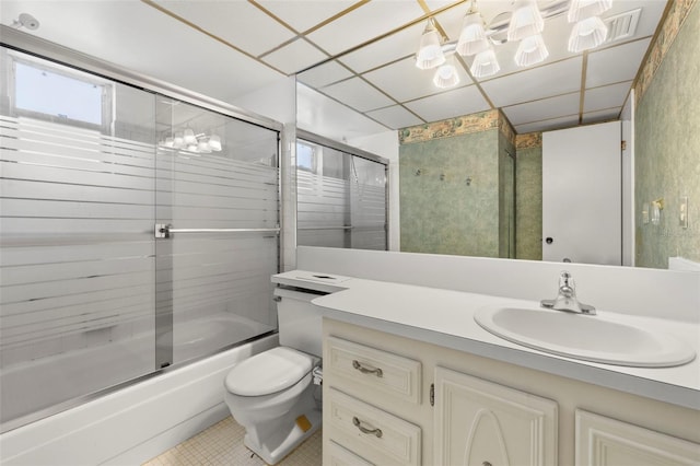 full bathroom featuring tile patterned floors, vanity, enclosed tub / shower combo, and toilet