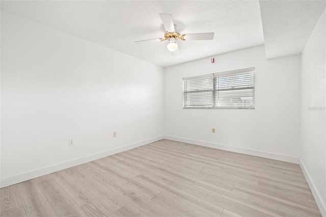 spare room featuring ceiling fan, a textured ceiling, and light hardwood / wood-style flooring