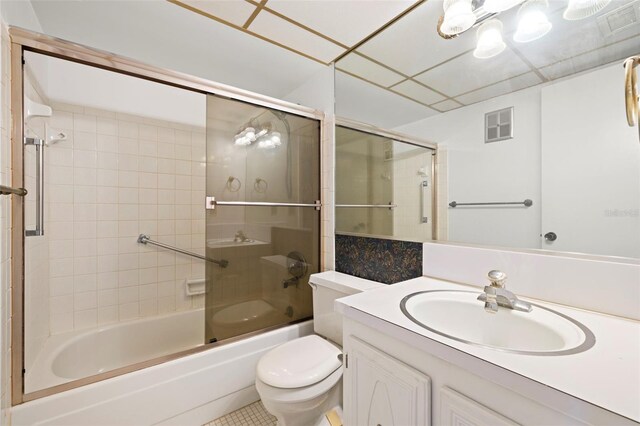 full bathroom featuring vanity, toilet, and enclosed tub / shower combo