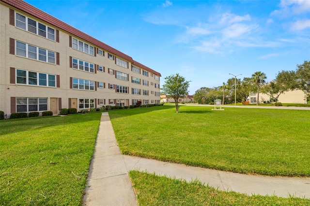 view of property's community with a yard