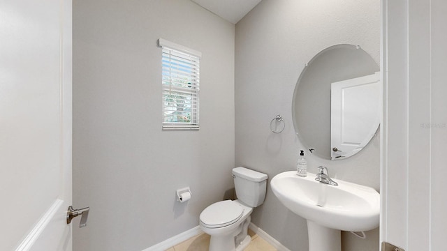 bathroom featuring toilet, sink, and tile patterned floors