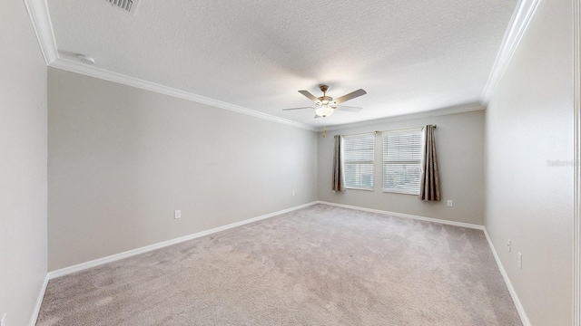 carpeted spare room featuring crown molding, a textured ceiling, and ceiling fan