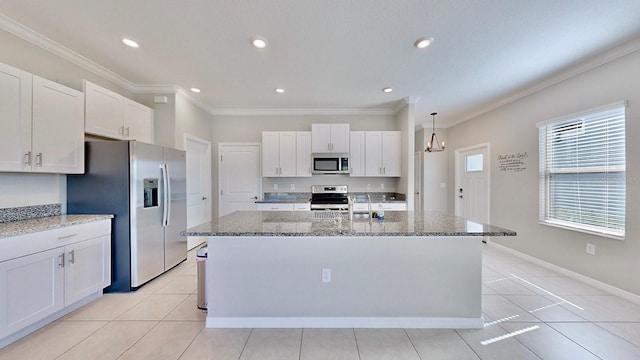 kitchen with white cabinets, a kitchen island with sink, and stainless steel appliances