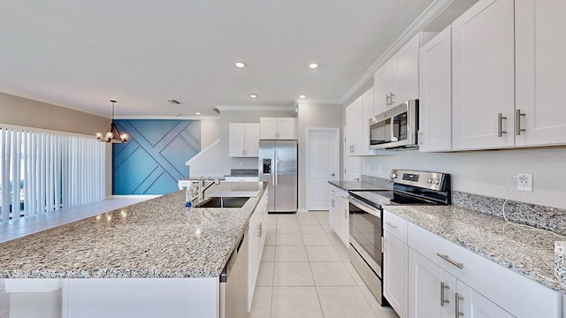 kitchen with stainless steel appliances, hanging light fixtures, sink, and white cabinets