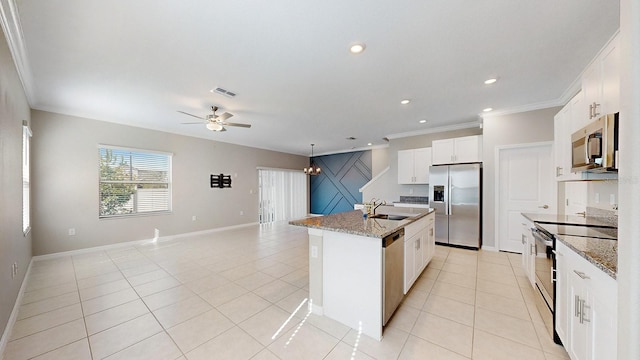 kitchen featuring an island with sink, white cabinetry, light tile patterned floors, appliances with stainless steel finishes, and light stone counters