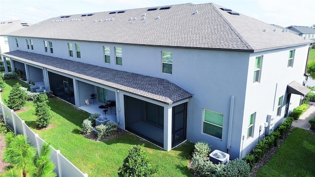 back of property with a patio, a lawn, central AC unit, and a sunroom