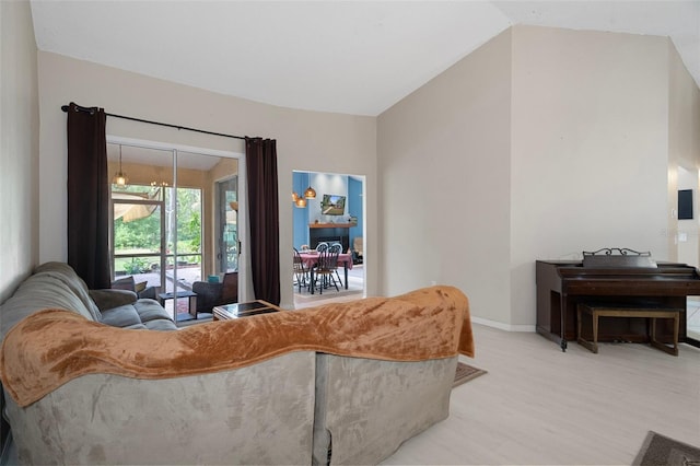 living room with light wood-type flooring and lofted ceiling