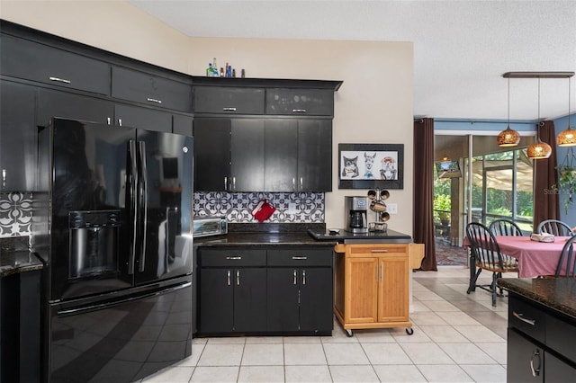 kitchen featuring tasteful backsplash, a textured ceiling, light tile patterned floors, hanging light fixtures, and black fridge with ice dispenser