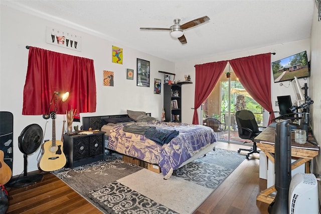 bedroom with dark hardwood / wood-style flooring, ceiling fan, and access to exterior