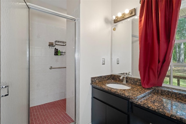 bathroom featuring vanity and a shower with door