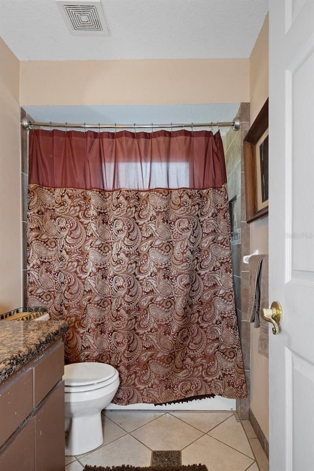 bathroom with walk in shower, tile patterned flooring, vanity, and toilet