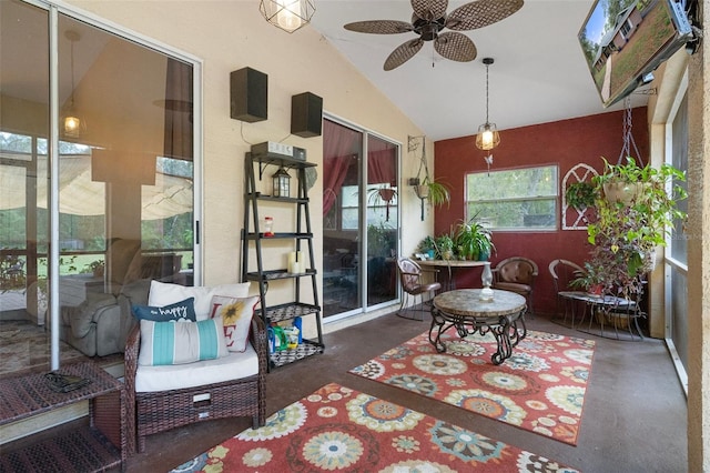 sunroom / solarium with ceiling fan and vaulted ceiling