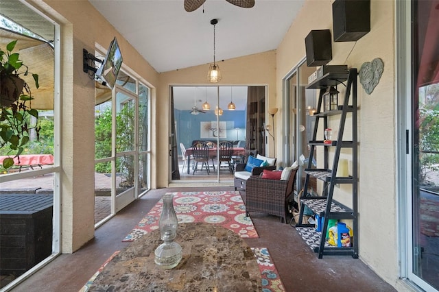 sunroom featuring lofted ceiling and ceiling fan