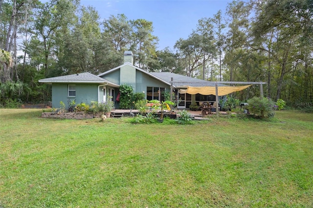 back of house with a yard and a patio area