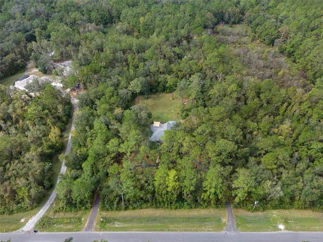 drone / aerial view with a wooded view