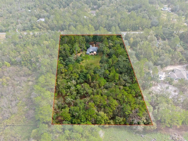 drone / aerial view with a wooded view