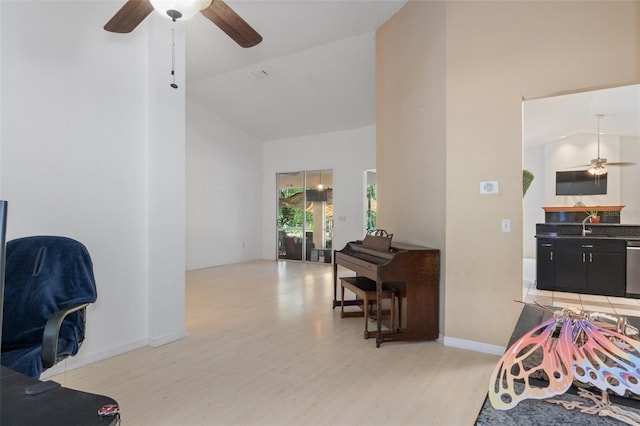 bedroom with high vaulted ceiling, baseboards, and light wood finished floors