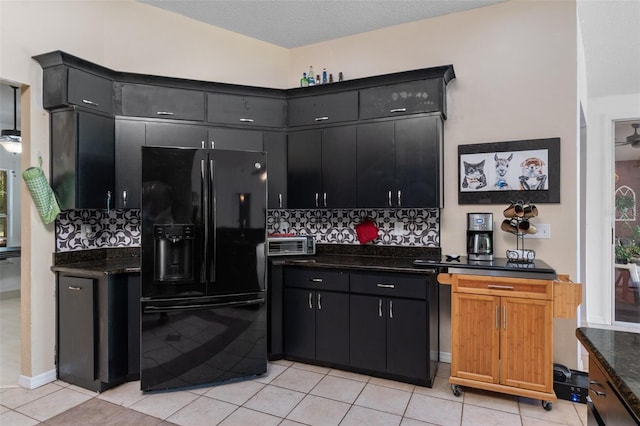 kitchen with black fridge with ice dispenser, a textured ceiling, decorative backsplash, light tile patterned floors, and dark cabinets