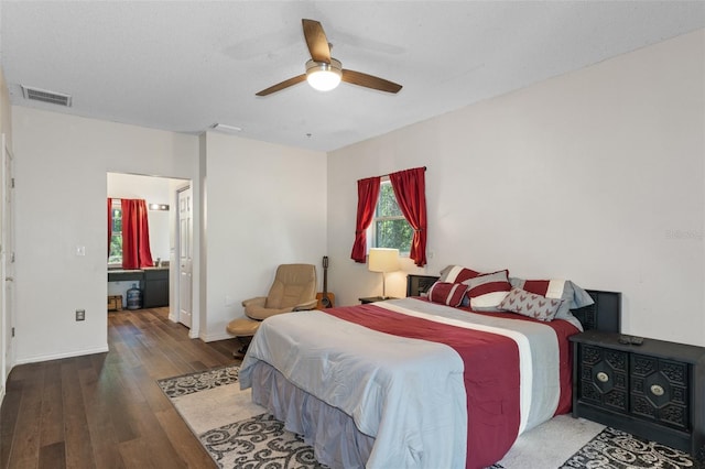 bedroom with baseboards, ceiling fan, visible vents, and wood finished floors