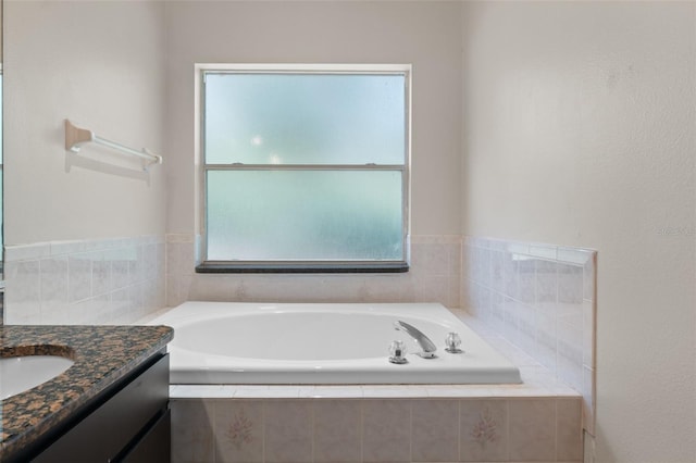 bathroom featuring vanity and a garden tub