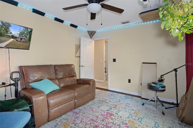 interior space featuring baseboards, visible vents, and a ceiling fan