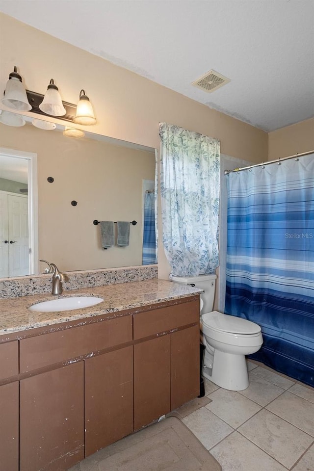 bathroom with visible vents, toilet, tile patterned floors, curtained shower, and vanity