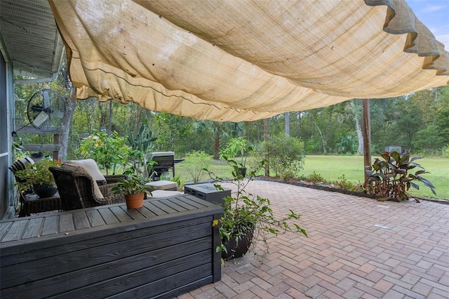 view of patio / terrace featuring a wooded view