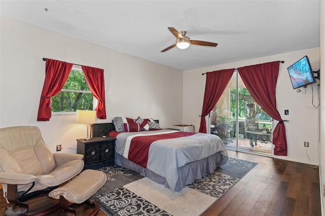 bedroom with hardwood / wood-style floors, multiple windows, ceiling fan, and access to outside
