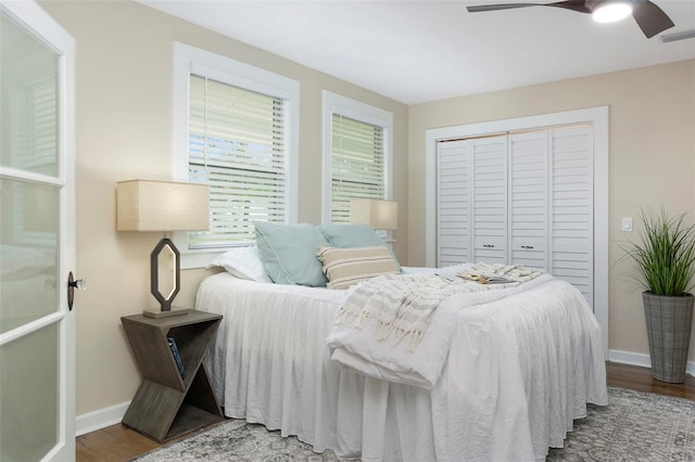 bedroom with a closet, ceiling fan, and wood-type flooring