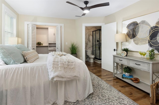 bedroom featuring a closet, dark hardwood / wood-style floors, ensuite bathroom, and ceiling fan