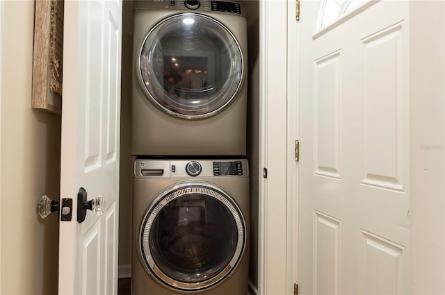 clothes washing area featuring stacked washer and dryer