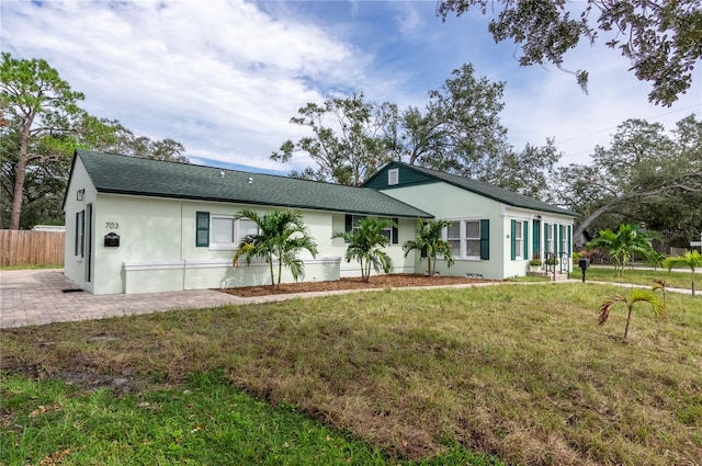 rear view of property featuring a lawn