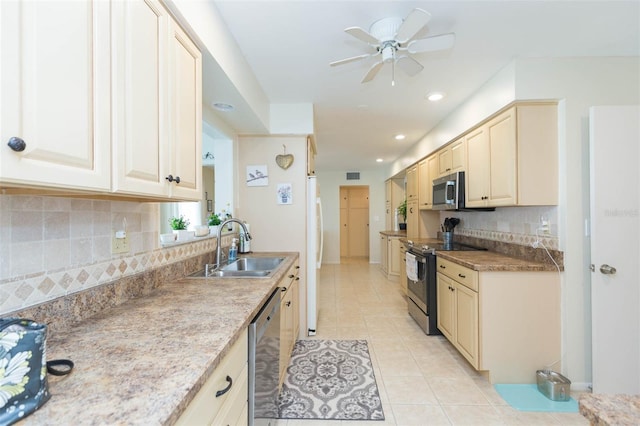 kitchen featuring tasteful backsplash, appliances with stainless steel finishes, sink, ceiling fan, and light tile patterned floors