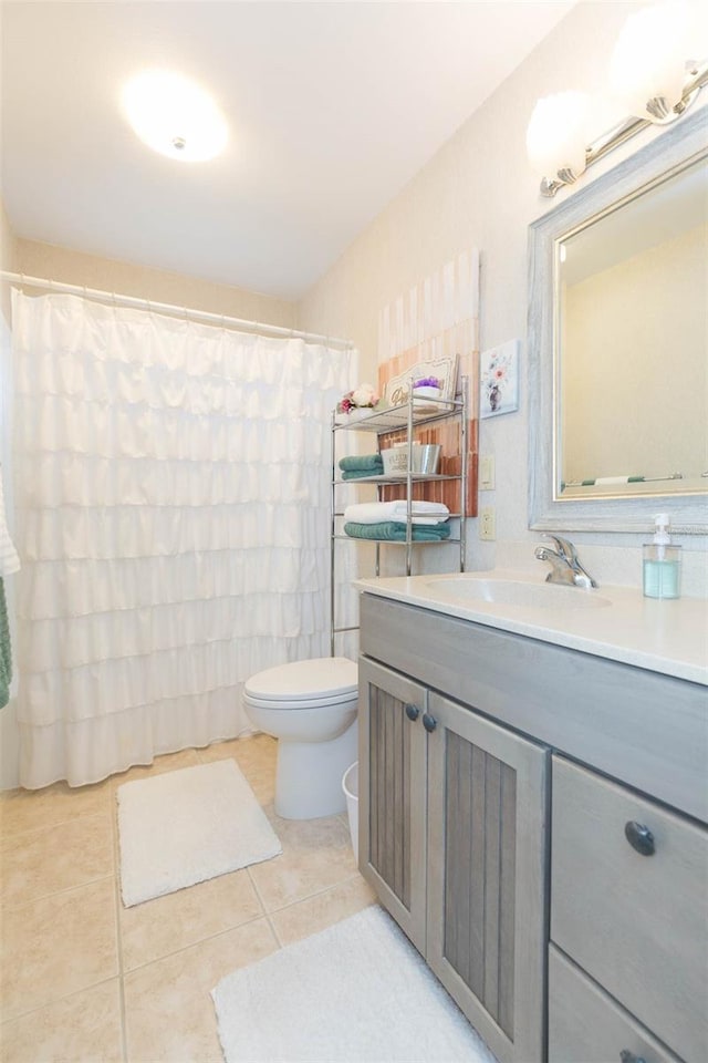 bathroom featuring vanity, toilet, tile patterned floors, and a shower with shower curtain