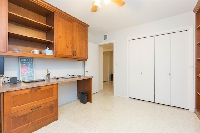 kitchen featuring built in desk and ceiling fan