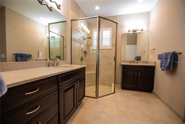 bathroom featuring vanity, a shower with shower door, and tile patterned floors