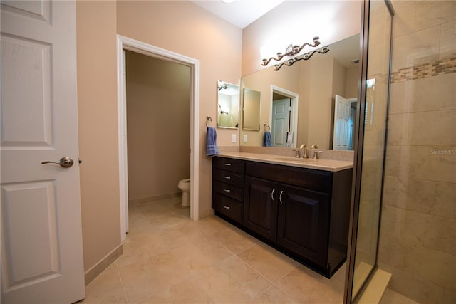 bathroom featuring vanity, tile patterned floors, toilet, and an enclosed shower