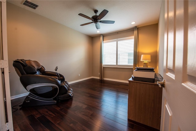 living area featuring dark hardwood / wood-style floors, a textured ceiling, and ceiling fan