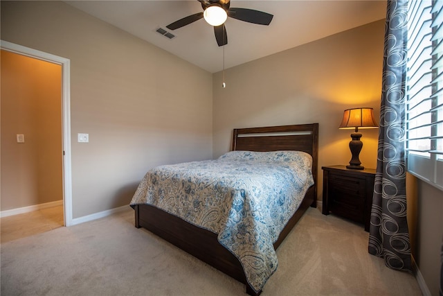 bedroom with ceiling fan and light colored carpet