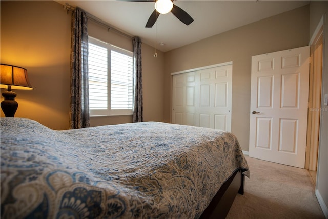 bedroom with a closet, light colored carpet, and ceiling fan