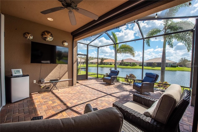 view of patio featuring a lanai and ceiling fan