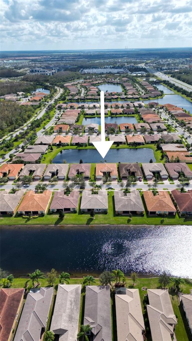 birds eye view of property with a water view