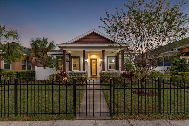 view of front of house with a lawn and covered porch