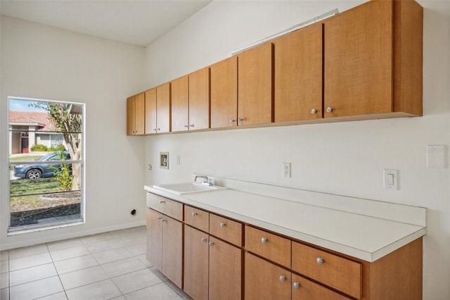 kitchen with light tile patterned floors and sink